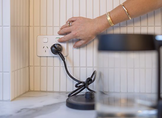 Electricians delivering electrical wiring, lighting, electrical outlets, switches, surge protection and fault detection services