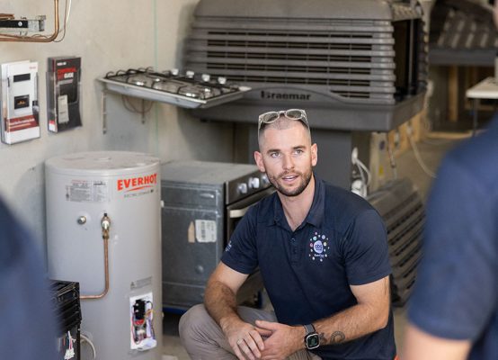 Electrician supporting electrical installation, switchboard, wiring and lighting for hot water systems